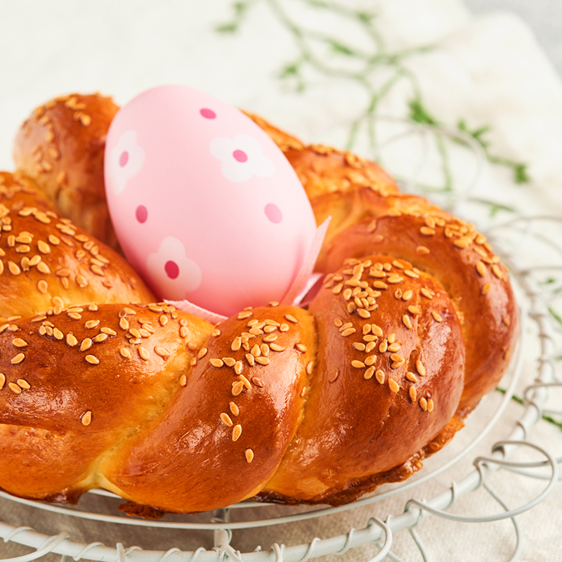 Spanish Easter cake. Traditional mona de pascua typical in Spain with boiled eggs eaten inside on light grey background. Typical food of the Spanish pastry Mona de Pascua. Top view. Mock up.