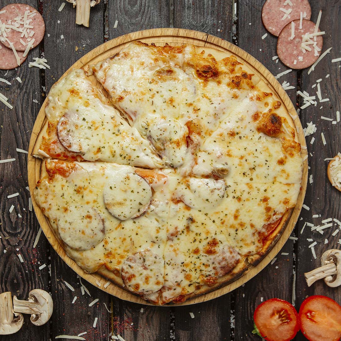 top view of pepperoni pizza with sausage, tomato sauce, cheese a